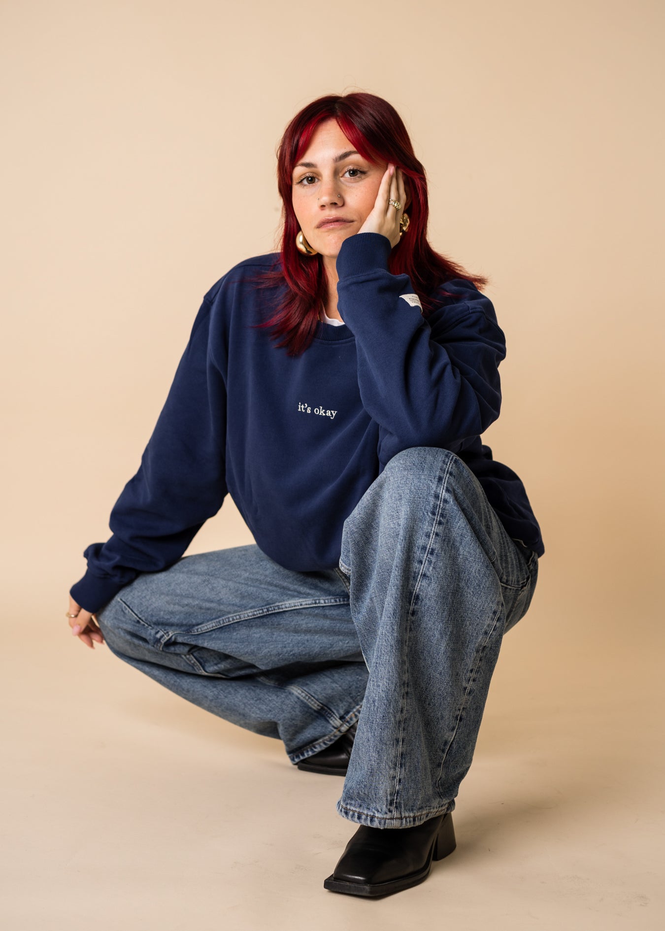 Woman wearing navy organic cotton crewneck by IT’S OKAY, relaxed fit.