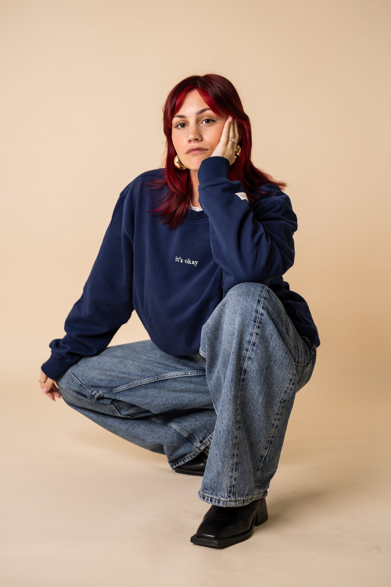 Woman wearing navy organic cotton crewneck by IT’S OKAY, relaxed fit.