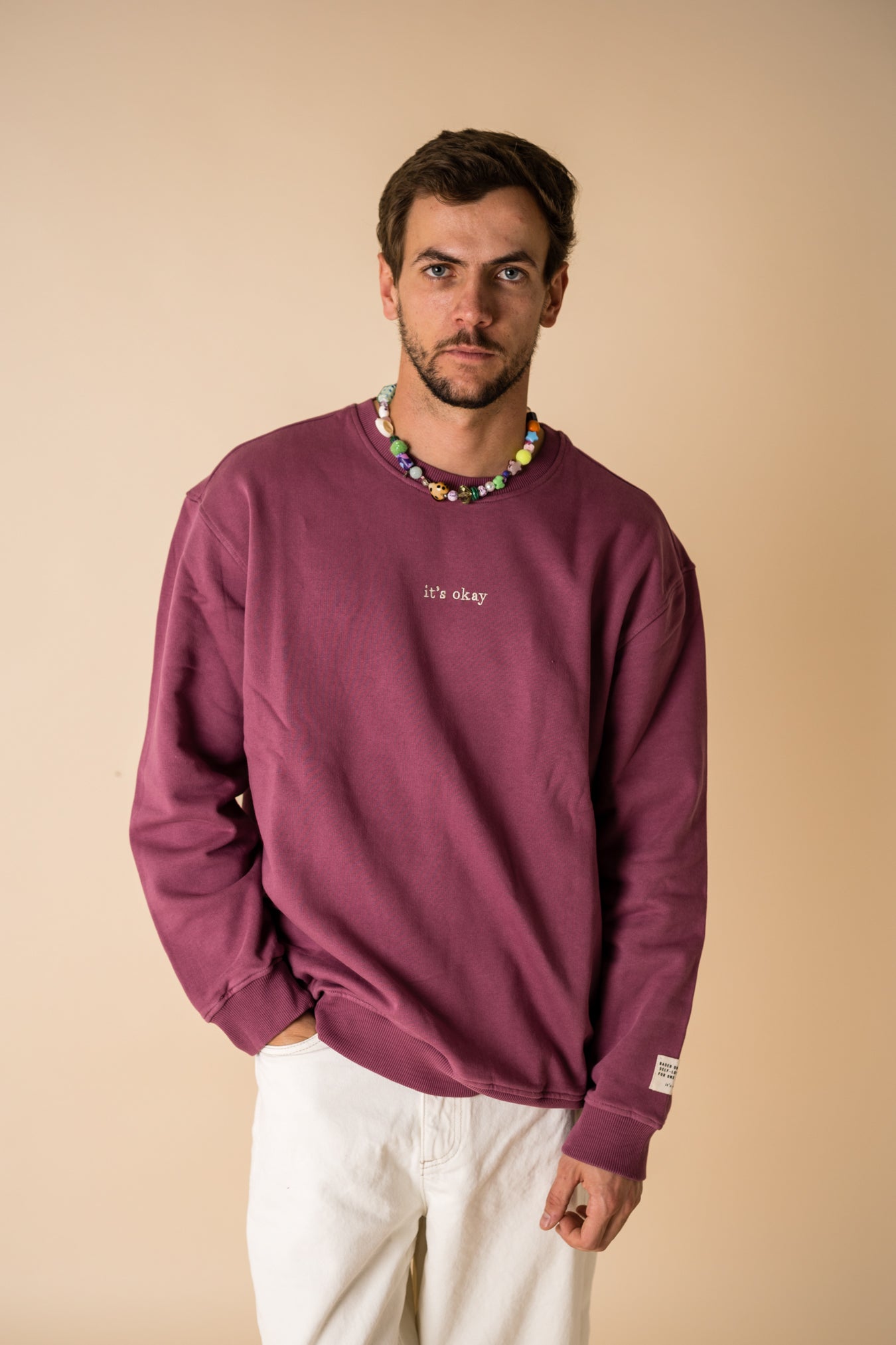 Model wearing IT’S OKAY organic cotton crewneck bordeaux burgundy, relaxed fit.